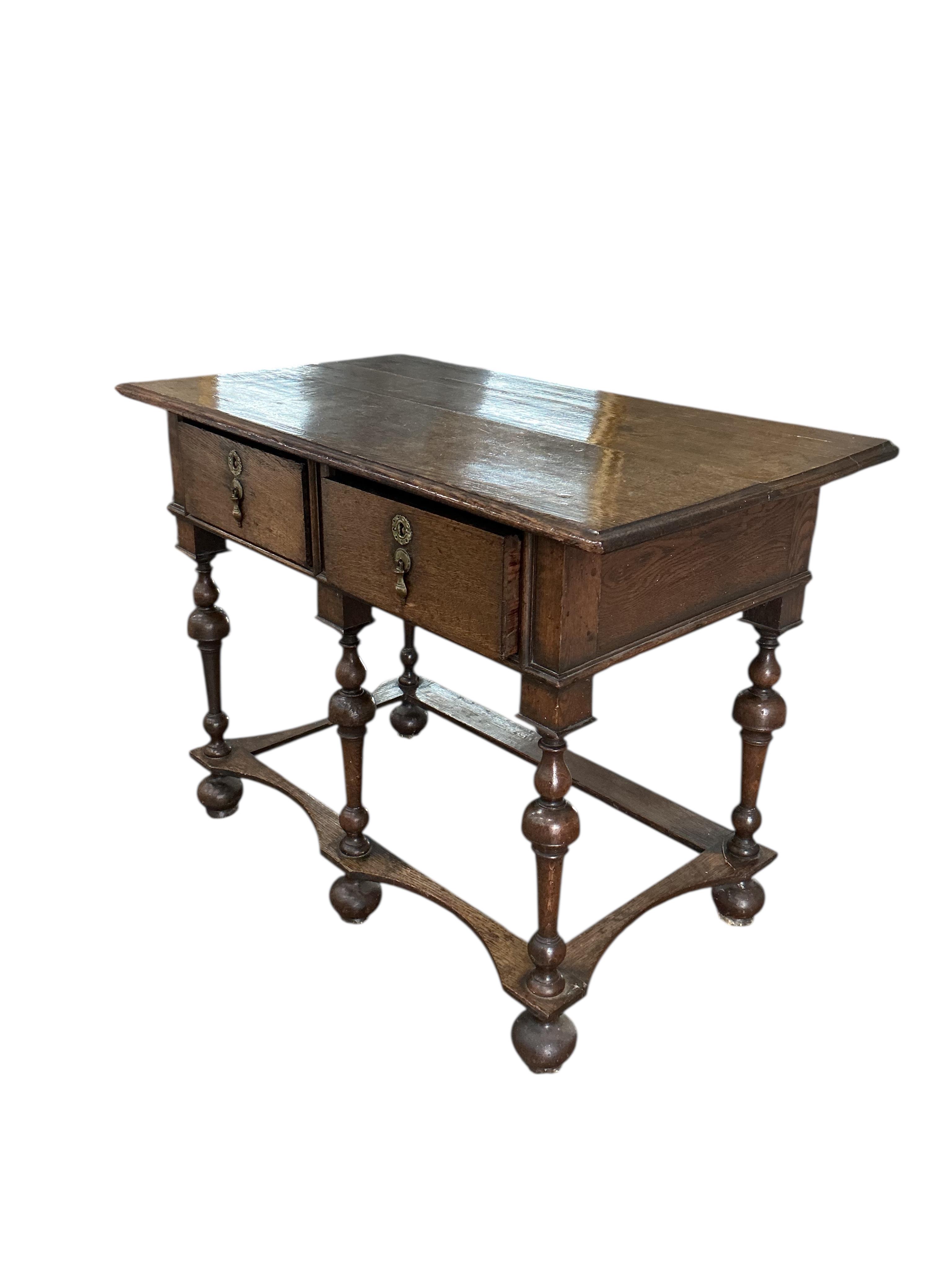 A William and Mary style oak two drawer side table, width 96cm, depth 54cm, height 72cm